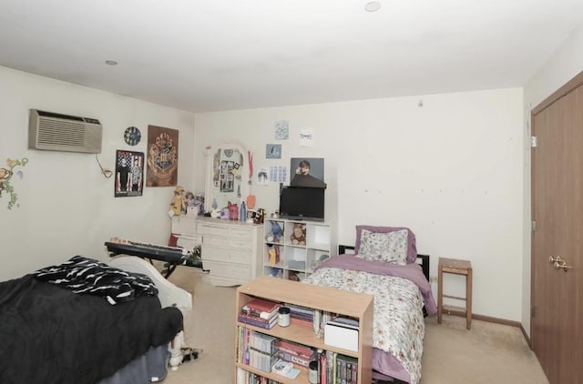 carpeted bedroom featuring an AC wall unit and baseboards