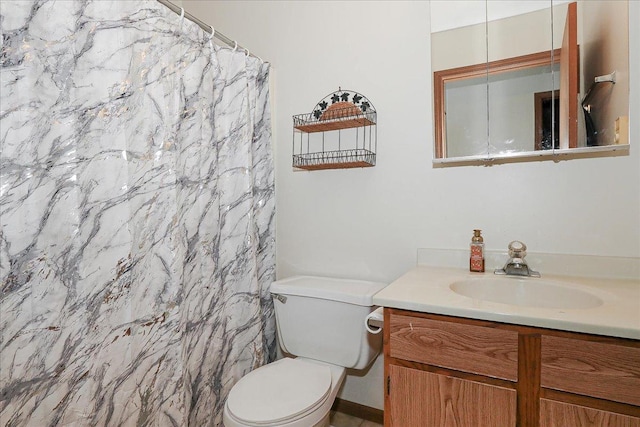 bathroom featuring vanity, curtained shower, and toilet