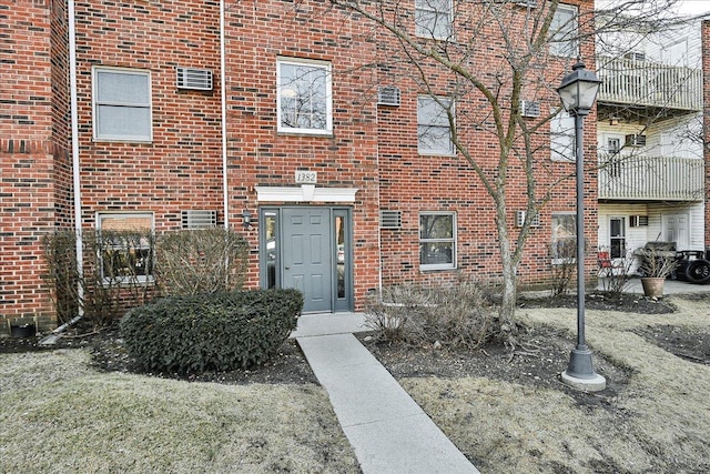 doorway to property with brick siding