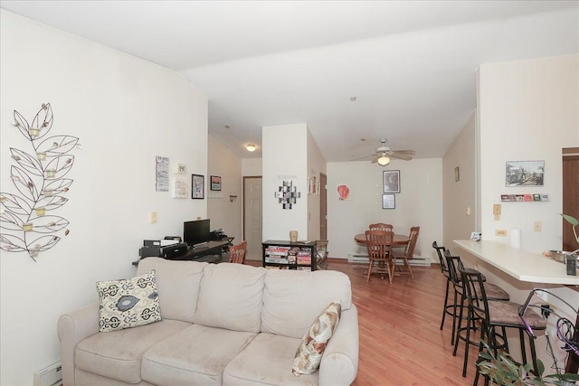 living room featuring light wood finished floors, a baseboard heating unit, ceiling fan, lofted ceiling, and baseboard heating