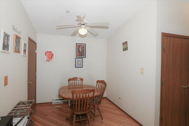 dining area with a baseboard heating unit, baseboards, light wood-type flooring, and ceiling fan