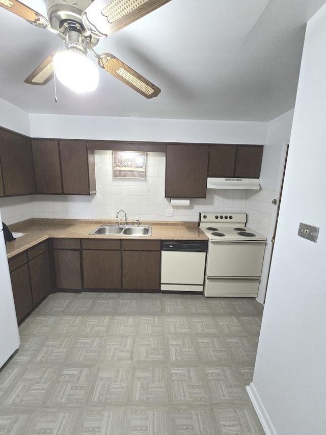 kitchen with a sink, under cabinet range hood, tasteful backsplash, white appliances, and dark brown cabinets