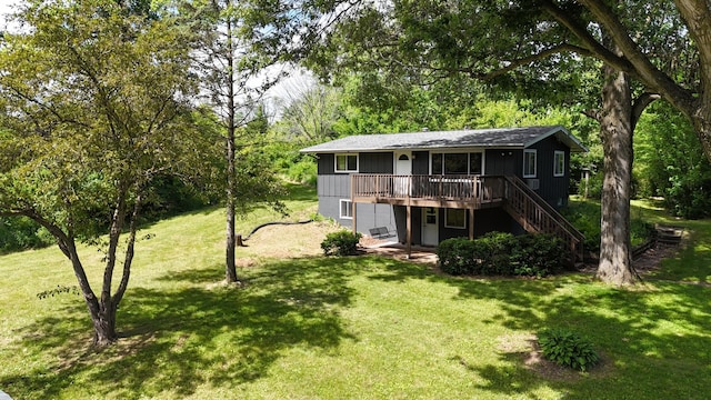 exterior space with stairway, a lawn, and a deck