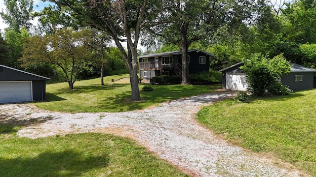 view of yard featuring a garage and an outdoor structure