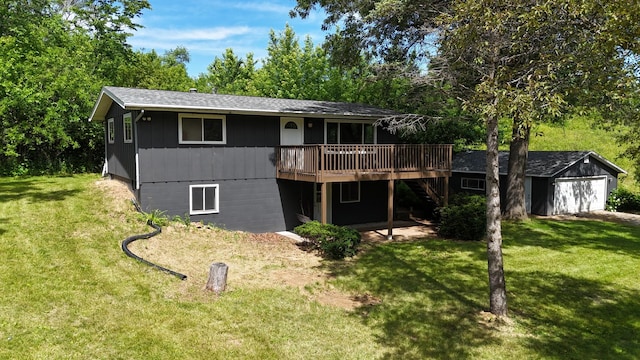 back of house featuring an outbuilding, a wooden deck, stairs, a garage, and a lawn