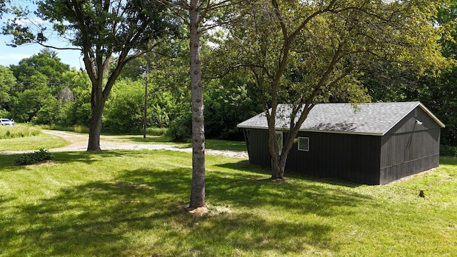 view of yard featuring a view of trees and an outdoor structure