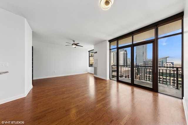 233 E 13th St Unit 2210, Chicago, IL 60605 - empty room featuring a ceiling fan, wood finished floors, expansive windows, and a city view