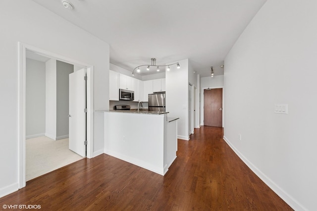 233 E 13th St Unit 2210, Chicago, IL 60605 - kitchen with stainless steel appliances, white cabinetry, a peninsula, and dark wood-style flooring