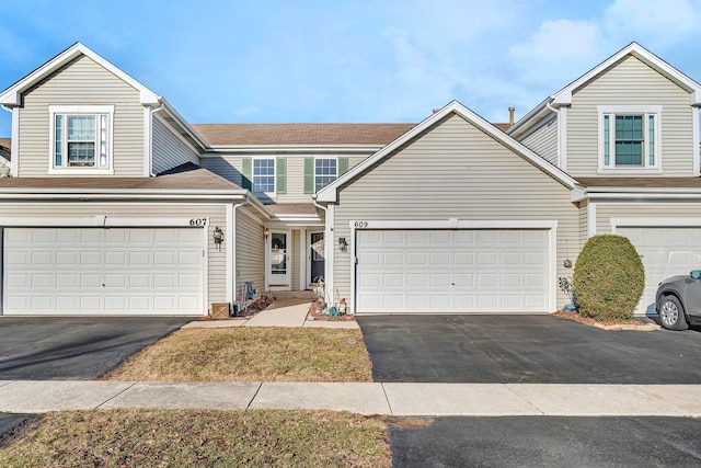 view of property featuring a garage and driveway