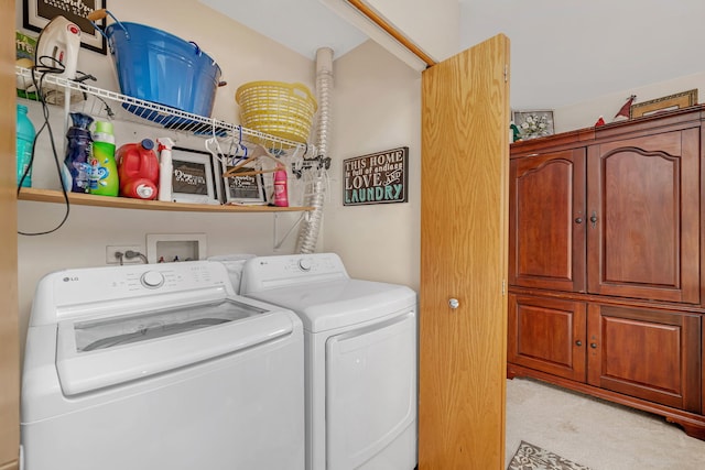 washroom featuring light carpet, laundry area, and washer and dryer