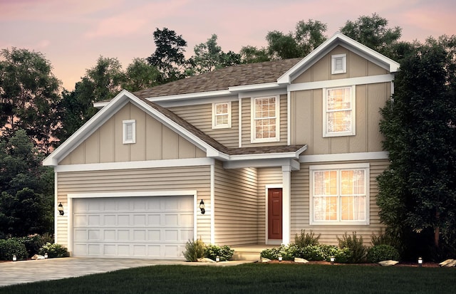 view of front of home featuring board and batten siding, a shingled roof, a garage, and concrete driveway