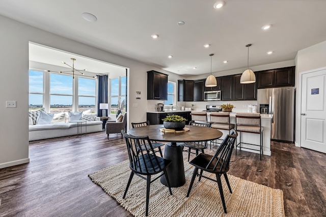 dining space featuring recessed lighting, baseboards, and dark wood finished floors