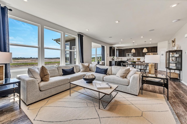 living room with recessed lighting and light wood-type flooring