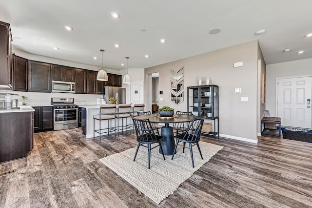 dining area featuring visible vents, recessed lighting, baseboards, and wood finished floors