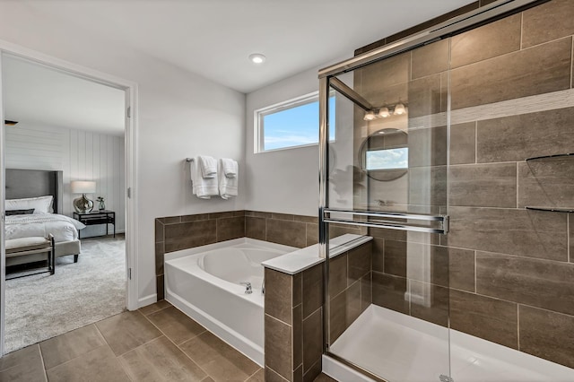 bathroom featuring ensuite bathroom, a garden tub, and a shower stall