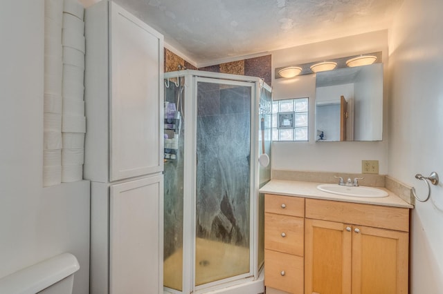 bathroom featuring vanity, toilet, and a stall shower