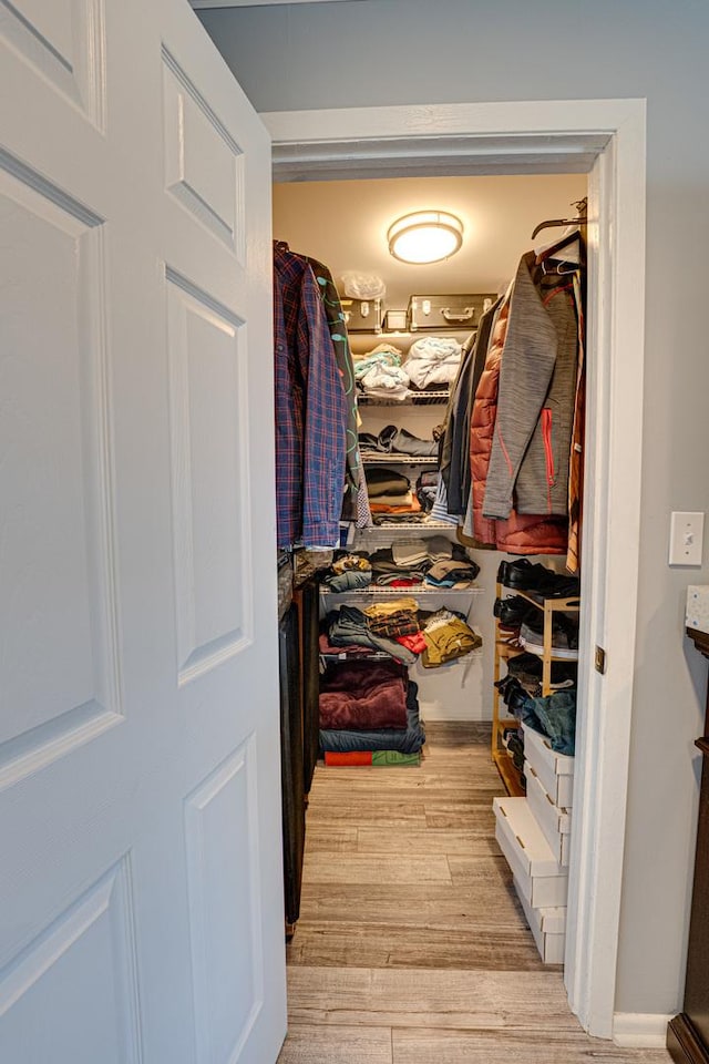 spacious closet with wood finished floors