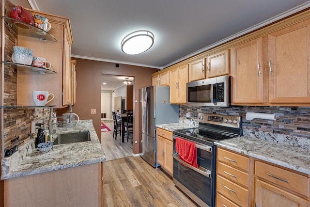 kitchen featuring tasteful backsplash, ornamental molding, light wood-style flooring, stainless steel appliances, and a sink