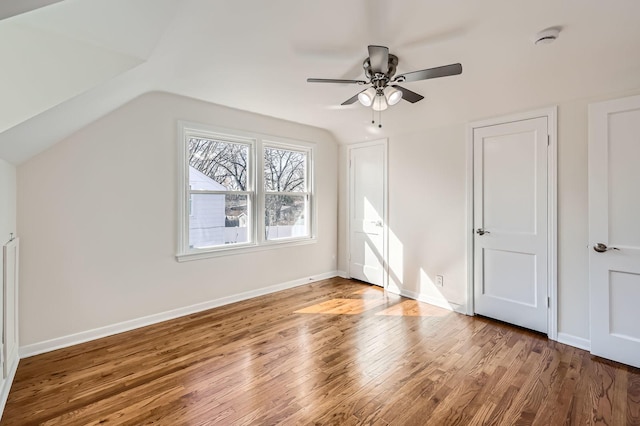 bonus room with a ceiling fan, lofted ceiling, baseboards, and wood finished floors