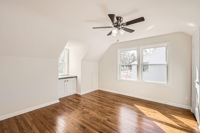 bonus room featuring ceiling fan, baseboards, hardwood / wood-style floors, and vaulted ceiling