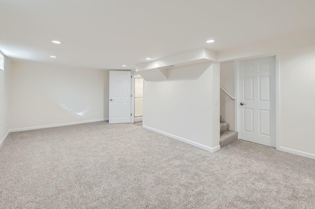 finished basement with stairway, recessed lighting, and carpet floors