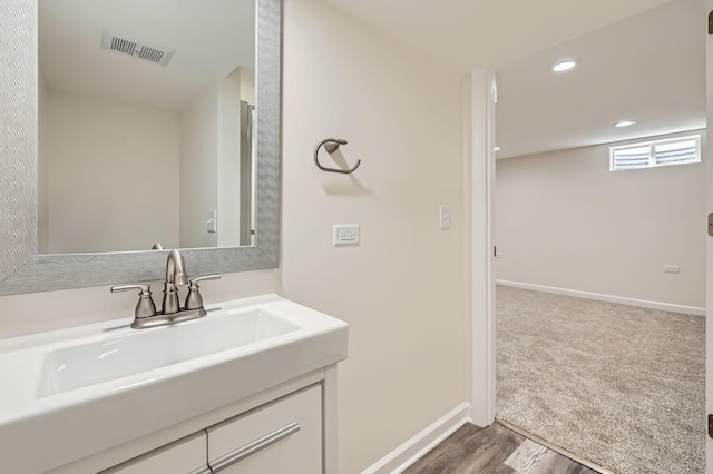 bathroom featuring recessed lighting, visible vents, baseboards, and vanity