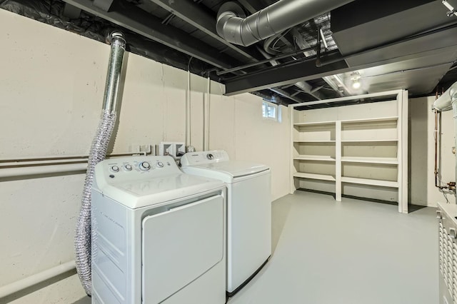 clothes washing area featuring washing machine and dryer and laundry area