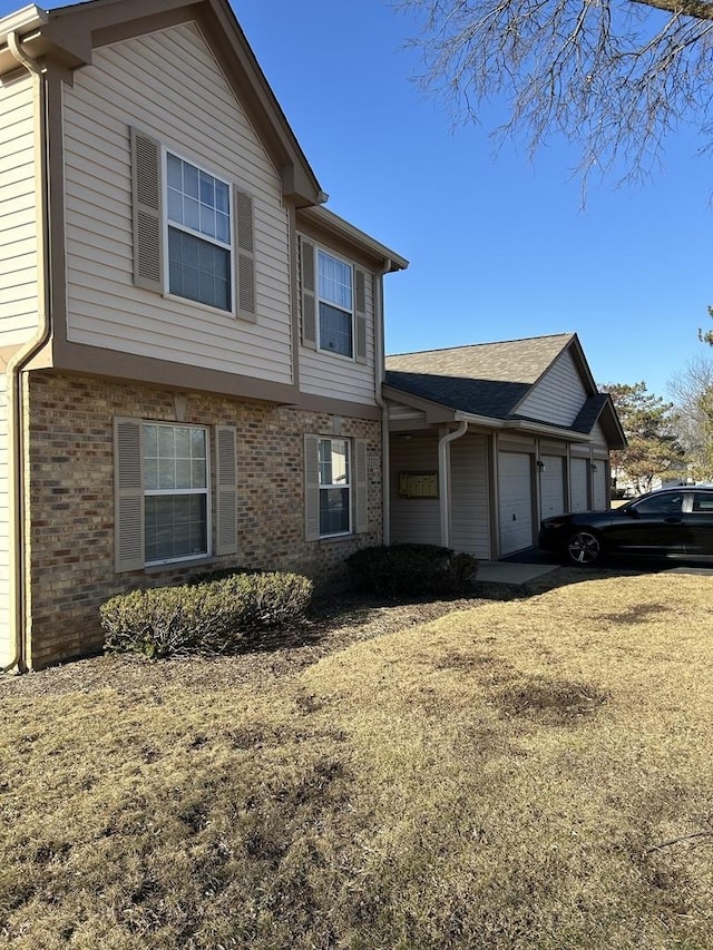 view of front of home with a garage and brick siding