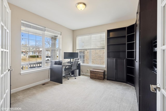 office featuring a wealth of natural light, baseboards, and carpet floors