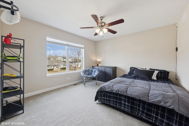 bedroom featuring baseboards, a ceiling fan, and carpet flooring