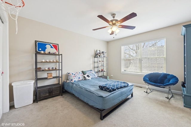 bedroom featuring baseboards, light carpet, and a ceiling fan