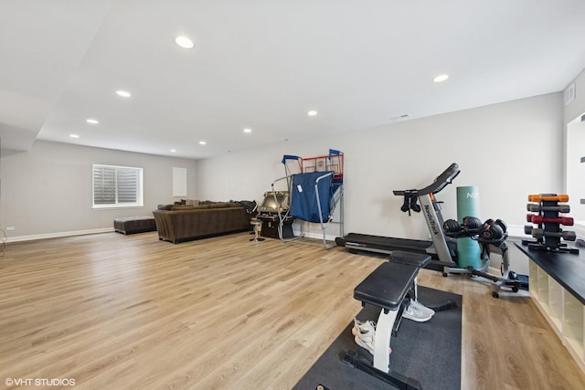 exercise area featuring recessed lighting, light wood-type flooring, and baseboards