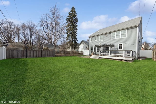 back of property with a wooden deck, a yard, and a fenced backyard