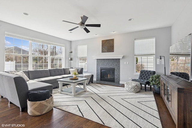 living area featuring recessed lighting, a tile fireplace, ceiling fan, and wood finished floors