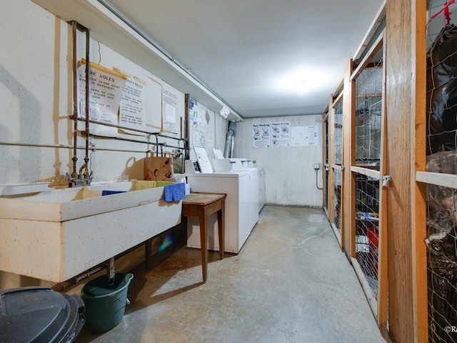 washroom with a sink and independent washer and dryer