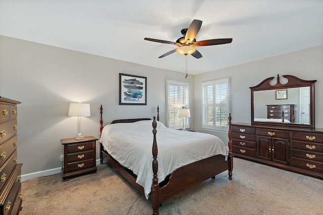 bedroom featuring a ceiling fan, baseboards, and light carpet