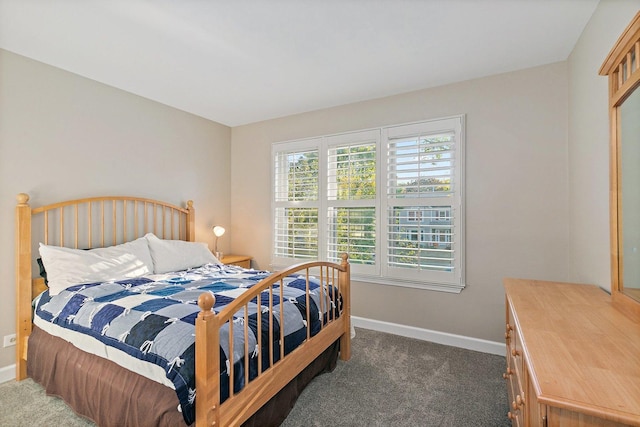 carpeted bedroom featuring baseboards