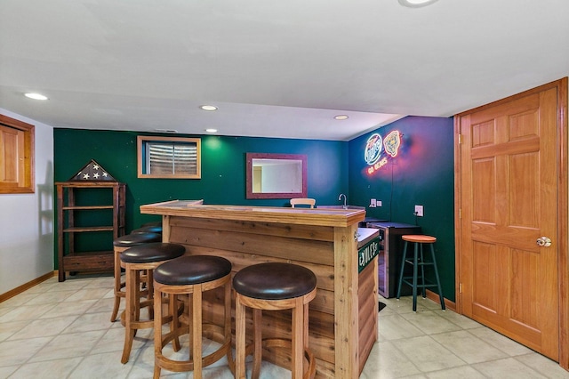 bar featuring a dry bar, recessed lighting, and baseboards