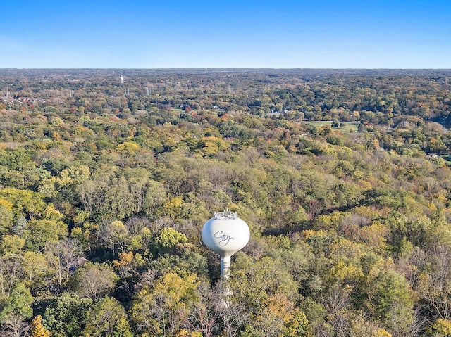 drone / aerial view with a wooded view