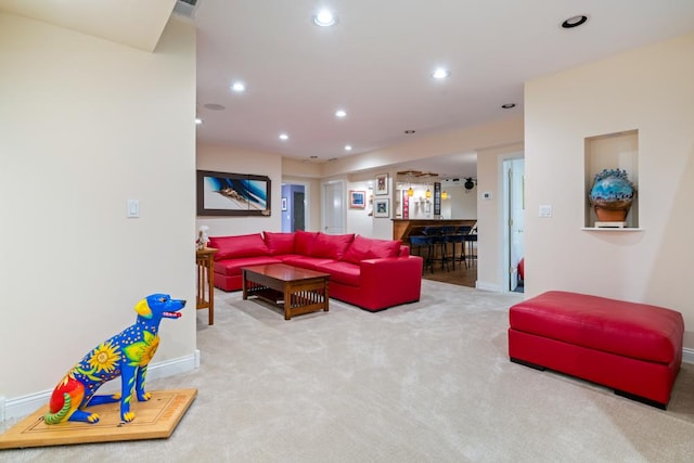 carpeted living room featuring visible vents, recessed lighting, a dry bar, and baseboards