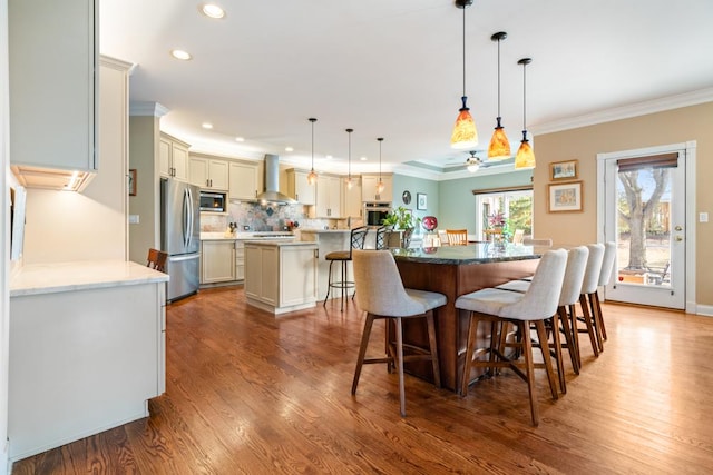 dining space featuring recessed lighting, wood finished floors, and ornamental molding