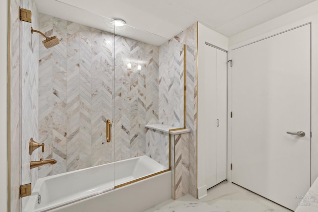 bathroom featuring marble finish floor and bath / shower combo with glass door