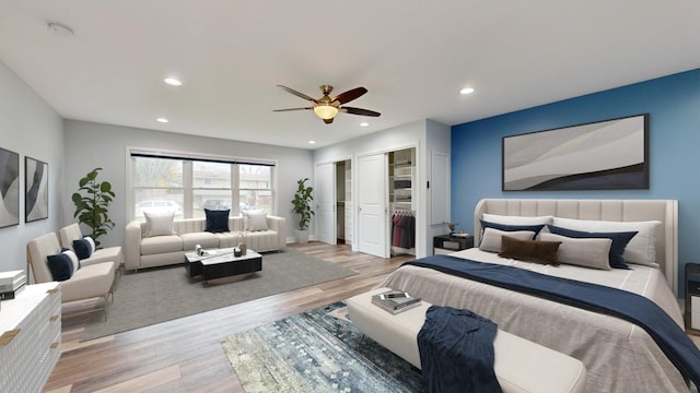 bedroom featuring multiple closets, recessed lighting, ceiling fan, and wood finished floors