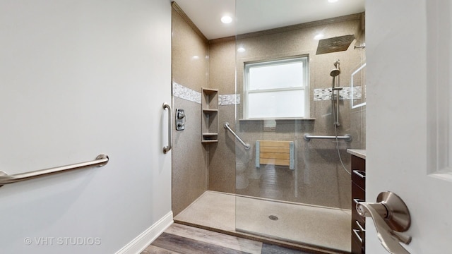 full bathroom featuring baseboards, wood finished floors, and a walk in shower