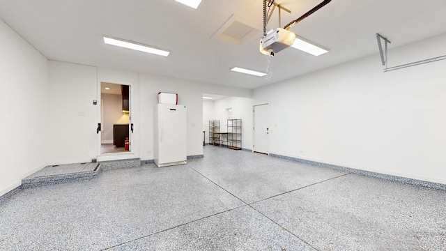 garage with freestanding refrigerator, a garage door opener, and baseboards