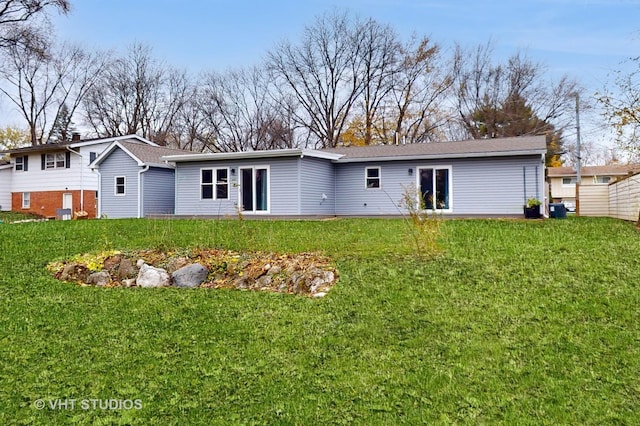 back of house featuring a yard