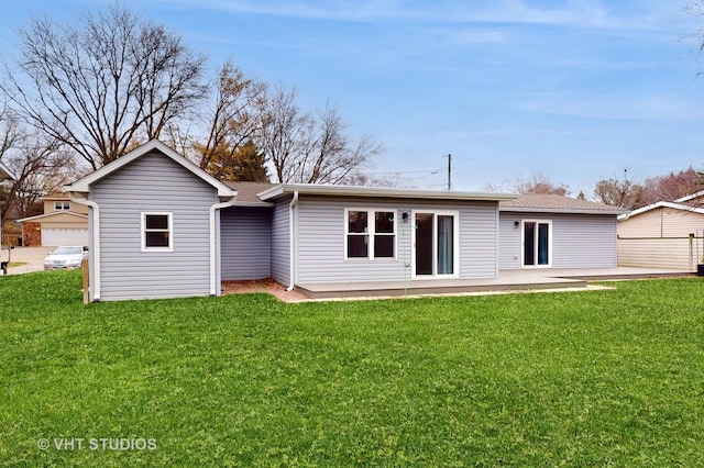 back of house with a patio area and a lawn