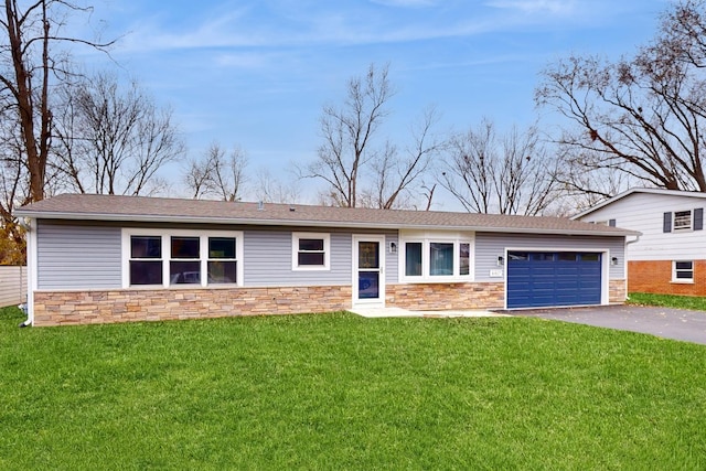 view of front of home featuring a front yard, stone siding, and driveway