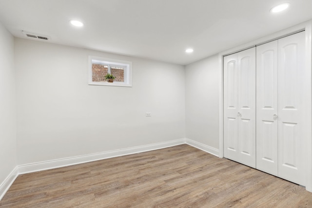 below grade area featuring recessed lighting, visible vents, and wood finished floors