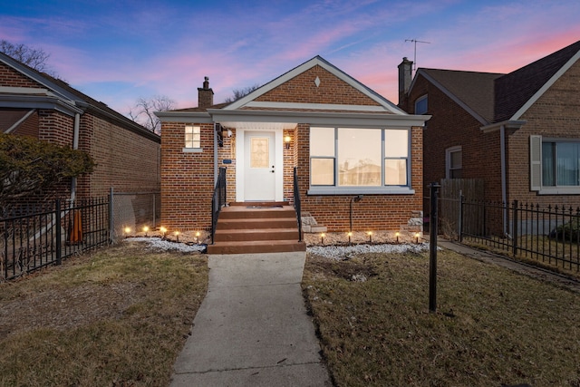 bungalow-style home featuring fence, brick siding, and a chimney